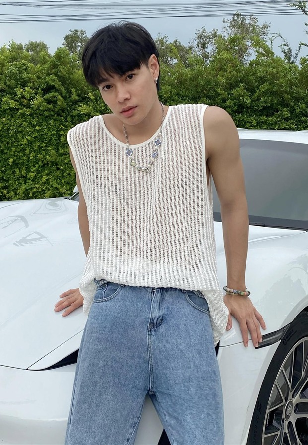 สกาย ในเสื้อกั๊กถักสีขาวคู่กางเกงยีนข้างรถสีขาว